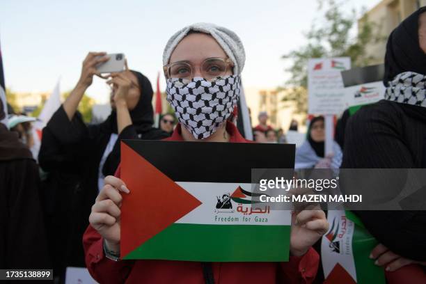 Bahraini carries a placard during a gathering in Manama on October 20 to express their solidarity with the Palestinian people.