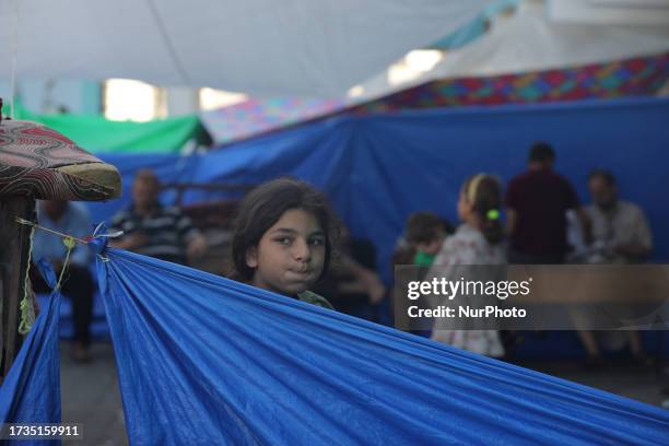 Displaced people at a United Nations Relief and Works Agency for Palestine Refugees school in Deir al-Balah, central Gaza Strip on October 20 amid...