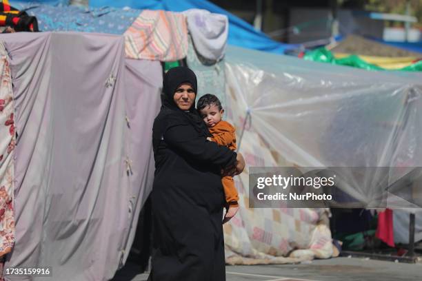 Displaced people at a United Nations Relief and Works Agency for Palestine Refugees school in Deir al-Balah, central Gaza Strip on October 20 amid...