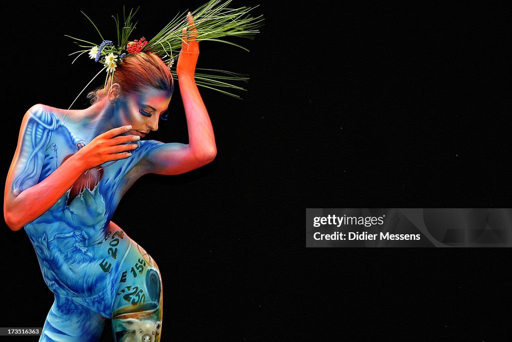 A participant poses with her body paintings designed by bodypainting ...