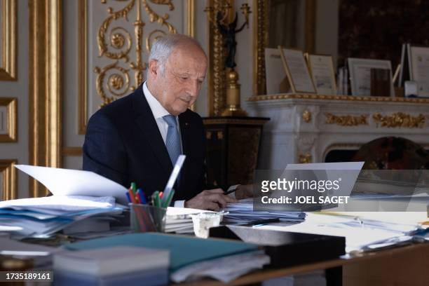 President of the French Constitutional Council Laurent Fabius poses in his office during a photo session in Paris on October 19, 2023