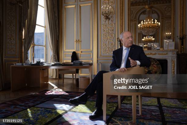 President of the French Constitutional Council Laurent Fabius poses in his office during a photo session in Paris on October 19, 2023