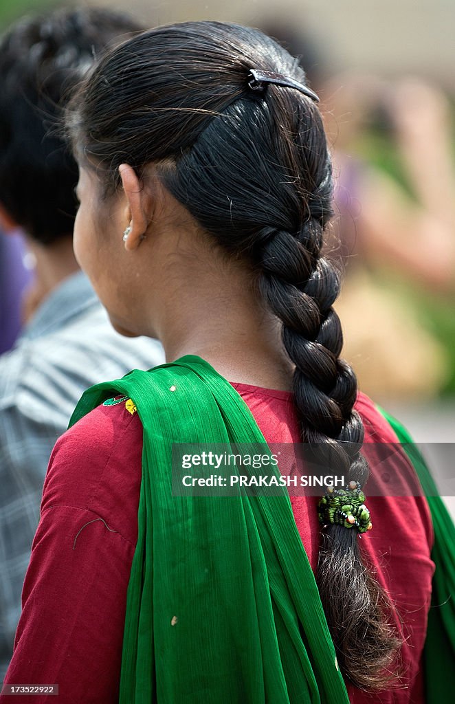 A Indian girl with a traditional hair style walks in New Delhi on... News  Photo - Getty Images