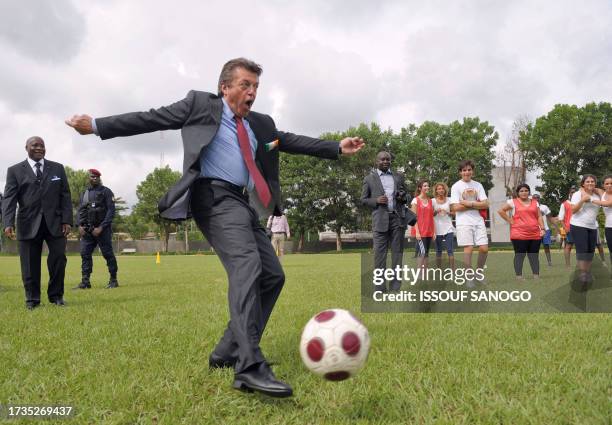 French Secretary of State for Cooperation Alain Joyandet kicks a ball on the pitch of the newly inaugurated French Lycee Blaise Pascal on May 5, 2009...