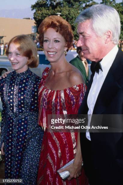Carrie Hamilton with her mother, American comedian, actress and singer Carol Burnett, wearing a shoulderless red outfit, and father, American...