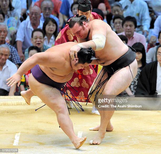 Bulgarian ozeki Kotooshu , whose real name is Kalojan Stefanov Mahljanov throws Chiyotairyu to win during day nine of the Grand Sumo Nagoya...