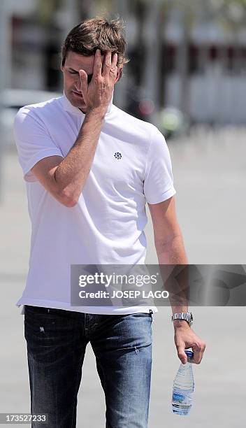 Barcelona's coach Tito Vilanova arrives for a press conference after the first training session of the season at the Sports Center FC Barcelona Joan...