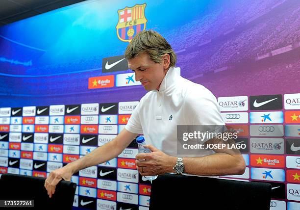 Barcelona's coach Tito Vilanova arrives for a press conference after the first training session of the season at the Sports Center FC Barcelona Joan...