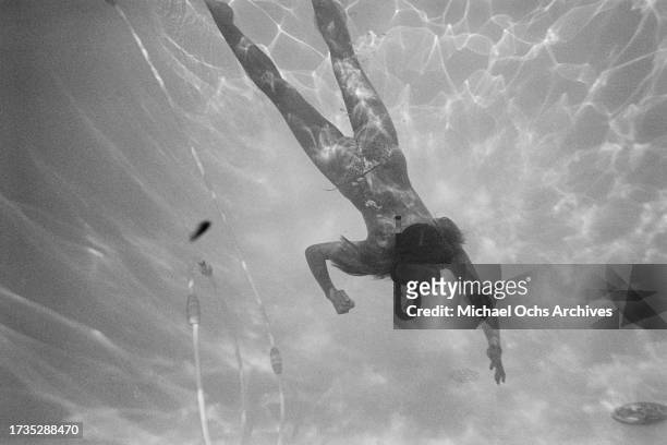 German actress and model Nastassja Kinski wearing a snorkel and mask as she swims in the swimming pool at her home in the Hollywood Hills, Los...