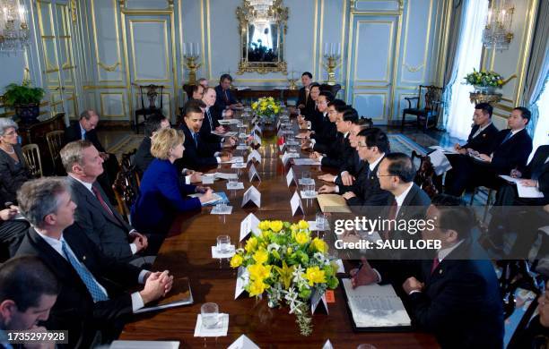 President Barack Obama and members of his Cabinet and senior aides attend a meeting with Chinese President Hu Jintao and senior aides at the Winfield...