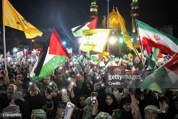 Demonstrators gather with Iranian and Palestinian flags and the yellow flags of the Lebanese Shiite movement Hezbollah during a protest in Tehran in...