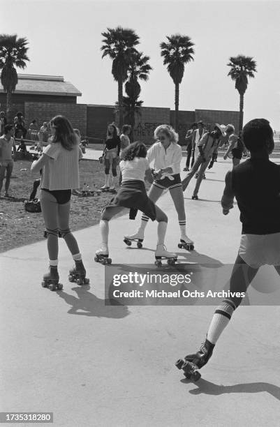 Roller skaters dancing on the beachfront of Venice Beach, in the Venice neighbourhood of Los Angeles, California, circa 1980.