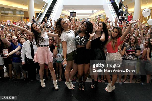 Fifth Harmony poses on stage after their performance at the Square One Mall on July 15, 2013 in Saugus, Massachusetts.