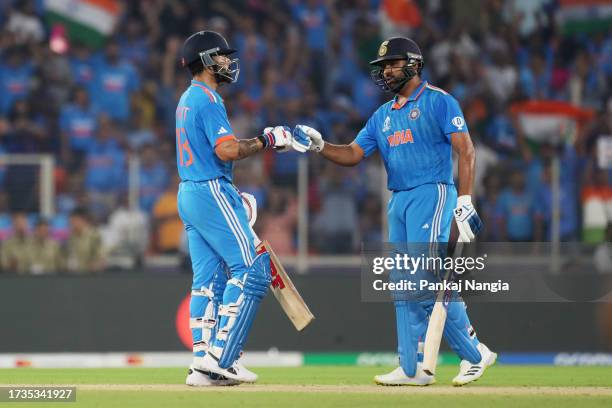 Virat Kohli and Rohit Sharma of India reactduring the ICC Men's Cricket World Cup India 2023 between India and Pakistan at Narendra Modi Stadium on...