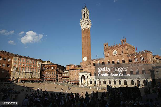 Tourists gather at the Piazza del Campo on July 5, 2013 in Siena, Italy. The region of Tuscany is among Italy's biggest tourist destinations.