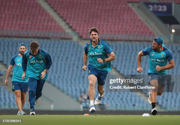 Adam Zampa, Mitch Marsh and Marcus Stoinis of Australia run during an Australian training session at the ICC Men's Cricket World Cup India 2023 at...