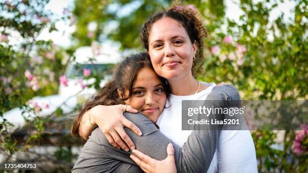 happy cute outdoor portrait of latina mother and teenage daughter, two beautiful women together with affection - adult portrait stock pictures, royalty-free photos & images