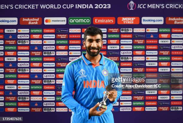 Jasprit Bumrah of India poses for a photo with the 'Player Of The Match' award after the team's victory during the ICC Men's Cricket World Cup India...