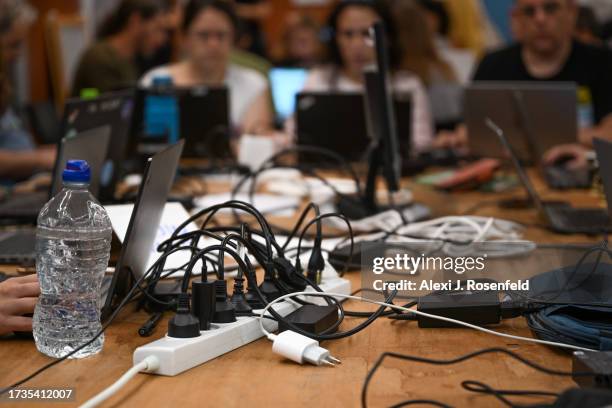 Multiple computer plus are all plugged into a power strip at the emergency situation room for the missing people on Shabbat, after Hamas militants...