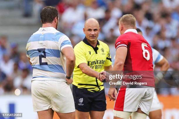 Referee Jaco Peyper interacts with Julian Montoya of Argentina and Jac Morgan of Wales having been replaced by Assistant Referee Karl Dickson during...