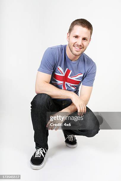casual dude - model crouching stock pictures, royalty-free photos & images