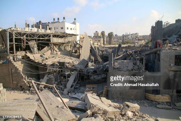 Palestinian citizens inspect damage to their homes caused by Israeli airstrikes on October 14, 2023 in Gaza City, Gaza. Many Gazan citizens have fled...
