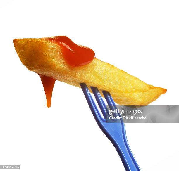 single french fry on tiny blue prong smothered in ketchup - ketchup stock pictures, royalty-free photos & images