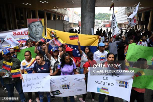 People gather in front of Venezuela's National Electoral Council headquarters in support of the referendum on a disputed zone with Guyana, in...
