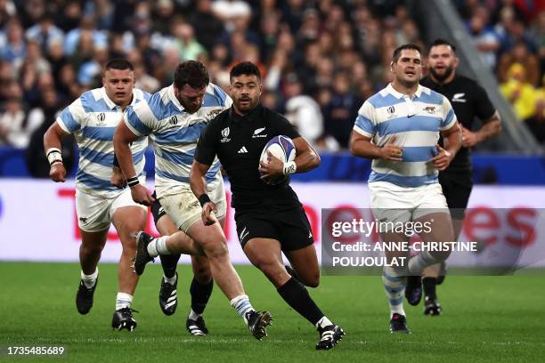 New Zealand's fly-half Richie Mo'unga runs with the ball during the France 2023 Rugby World Cup semi-final match between Argentina and New Zealand at...