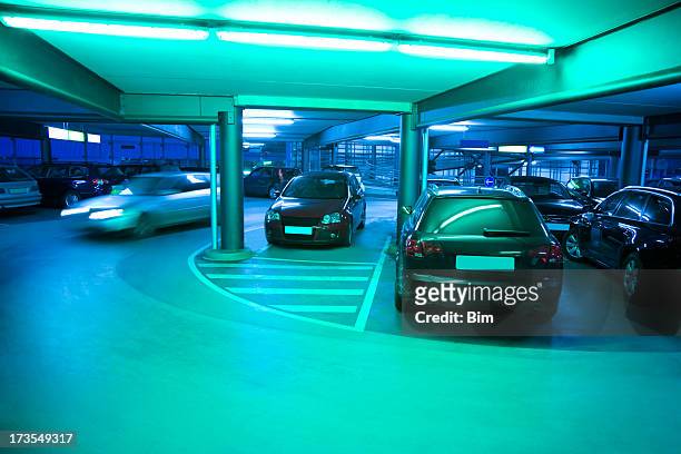 illuminated parking garage with cars - entry car stock pictures, royalty-free photos & images