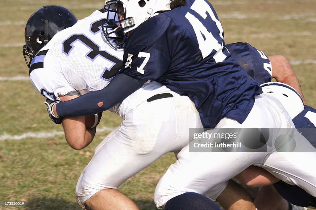 Football player being tackled