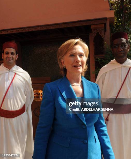 Secretary of State Hillary Clinton walks past doormen in the Palmeraie Golf Palace in Marrakesh on November 3, 2009 prior to her departure to Cairo....