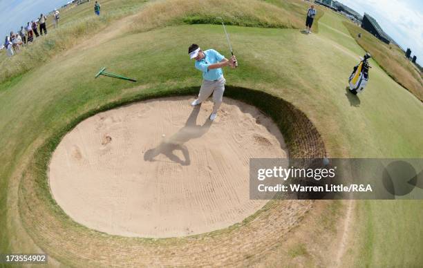 Louis Oosthuizen of South Africa hits from a bunker on the 13th hole ahead of the 142nd Open Championship at Muirfield on July 16, 2013 in Gullane,...