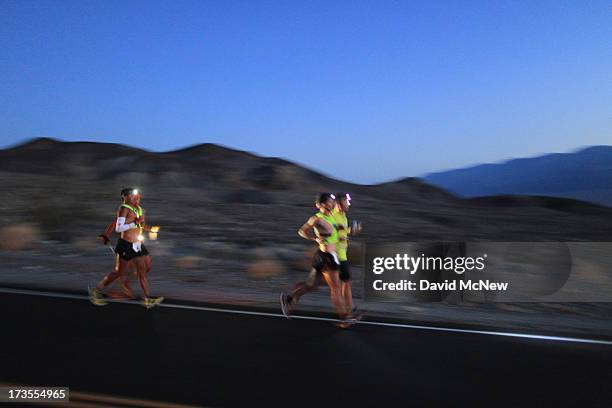 Oswaldo Lopez of Madera, California and Carlos Alberto of Portugal run wearing headlamp near Panamint Springs as night falls during the AdventurCORPS...