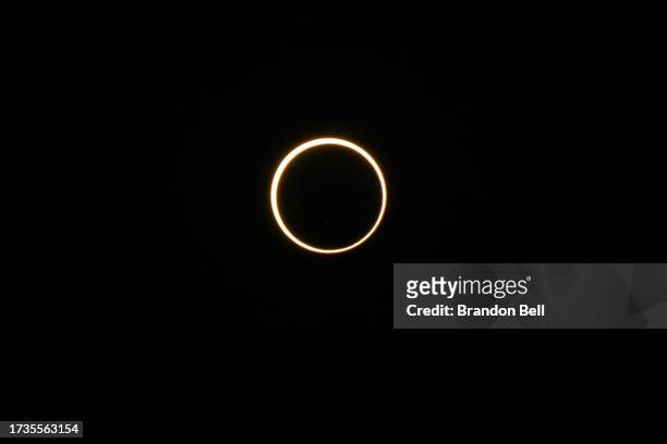 The moon passes in front the sun during an annular solar eclipse on October 14, 2023 in Kerrville, Texas. Differing from a total solar eclipse, the...