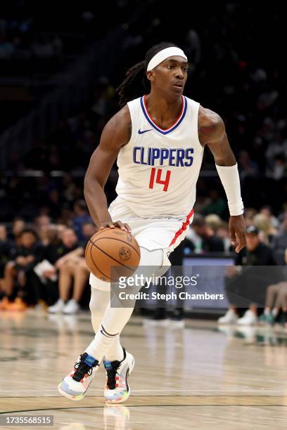 Terance Mann of the LA Clippers dribbles against the Utah Jazz during the third quarter of the Rain City Showcase in a preseason NBA game at Climate...