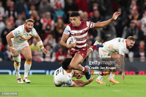 Kai Pearce-Paul of Wigan Warriors is tackled by Tyrone May of Catalans Dragons during the Betfred Super League Final match between Wigan Warriors v...