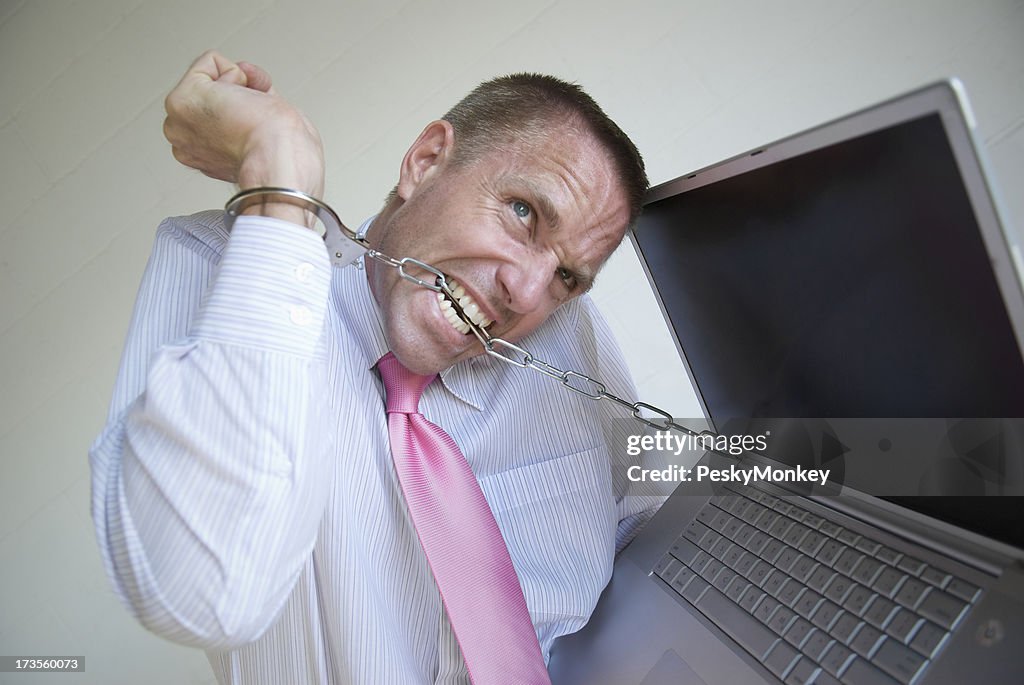 Handcuffed Businessman Tries to Break Laptop Chains