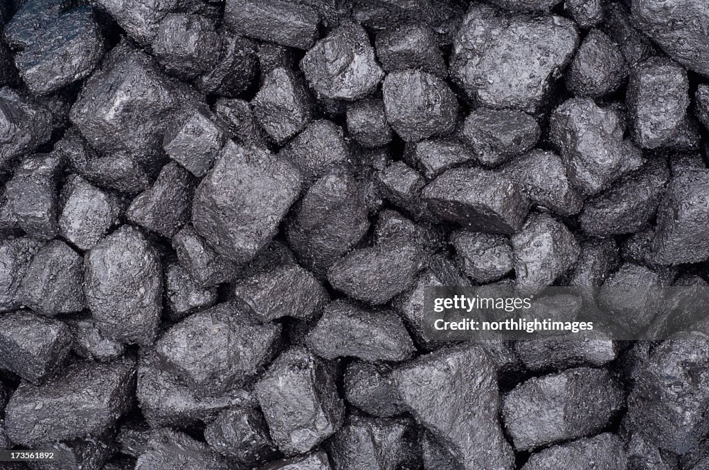 A close up of some grey dirty bricks of coal