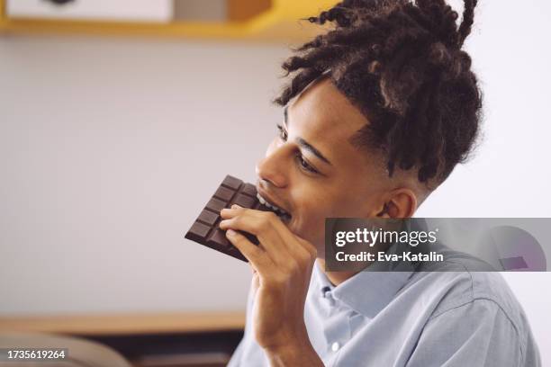 eating chocolate - eating chocolate stock pictures, royalty-free photos & images