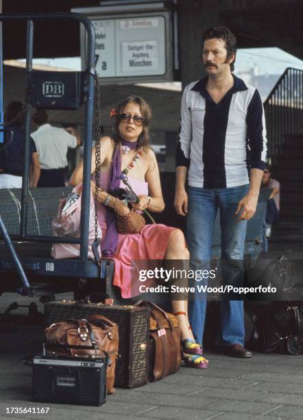 English rock musician Eric Clapton with girlfriend, model and photographer Pattie Boyd at a railway station in Germany, circa 1977. Boyd had recently...