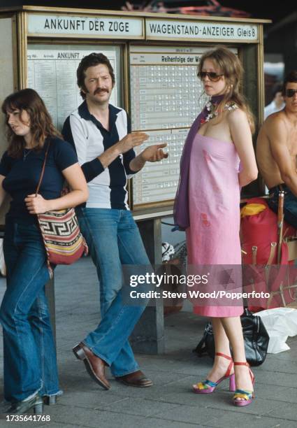 English rock musician Eric Clapton with girlfriend, model and photographer Pattie Boyd at a railway station in Germany, circa 1977. Boyd had recently...