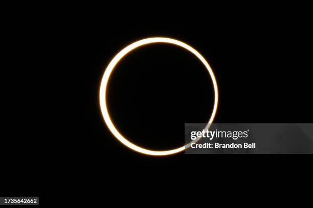 The moon descends over the sun's horizon during an annular solar eclipse on October 14, 2023 in Kerrville, Texas. Differing from a total solar...