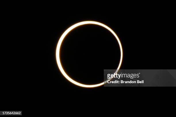 The moon descends over the sun's horizon during an annular solar eclipse on October 14, 2023 in Kerrville, Texas. Differing from a total solar...