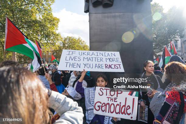 Young demonstrator holds a placard in support of Palestine at Downing street on October 14, 2023 in London, England. Groups supporting Palestine...
