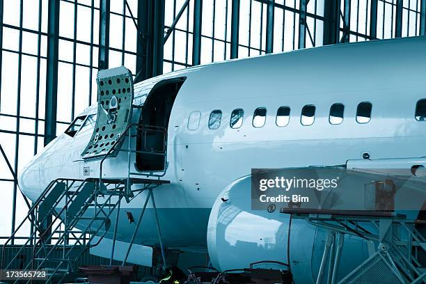 commercial airplane maintenance check  in hangar - door hanger stock pictures, royalty-free photos & images