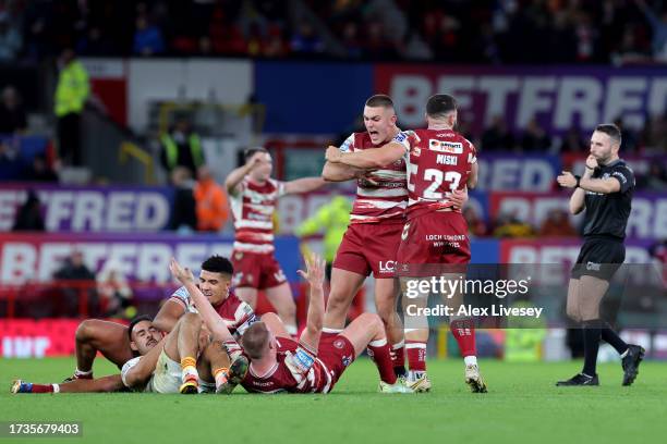 Brad O’Neill and Abbas Miski of Wigan Warriors celebrate with teammates after the team's victory during the Betfred Super League Final match between...