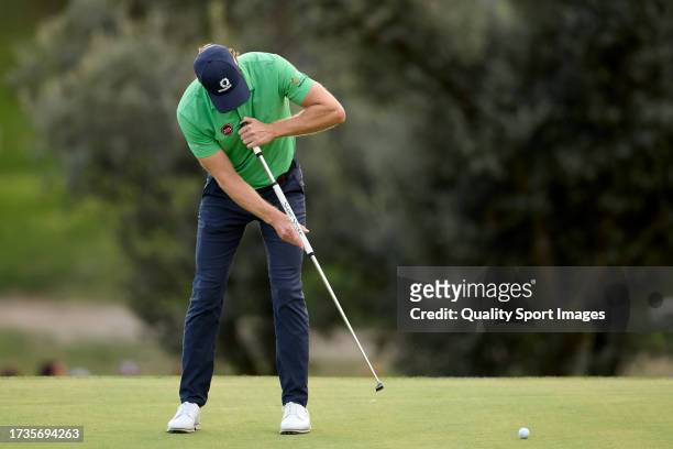 Wil Besseling of Netherlands plays a putt on the 18th hole on Day Three of the acciona Open de Espana presented by Madrid at Club de Campo Villa de...