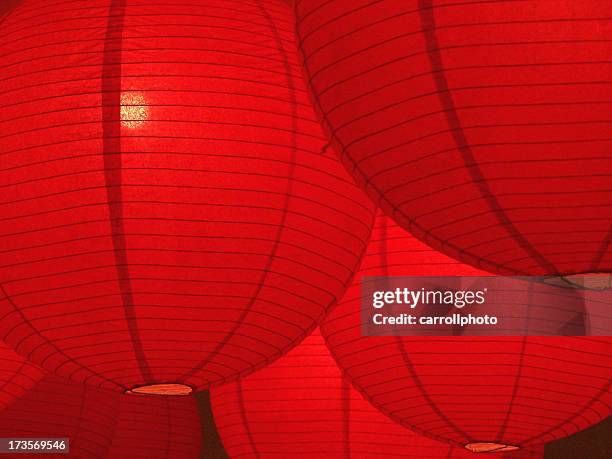 hanging red paper lanterns glowing - lantern stock pictures, royalty-free photos & images