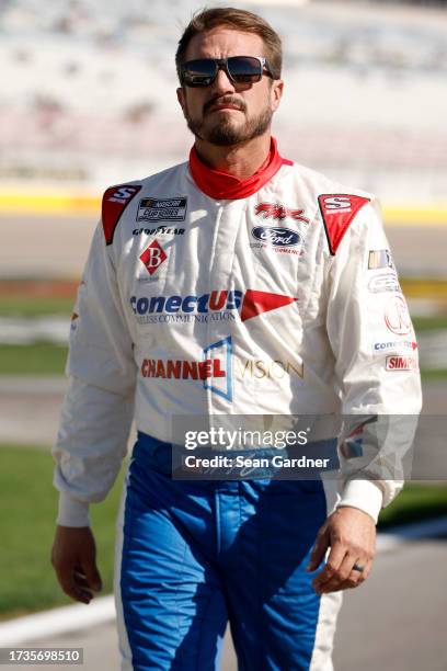 Yeley, driver of the ConectUS Ford, walks the grid during qualifying for the NASCAR Cup Series South Point 400 at Las Vegas Motor Speedway on October...